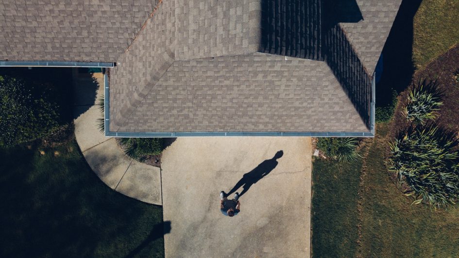 man standing in front of house during daytime